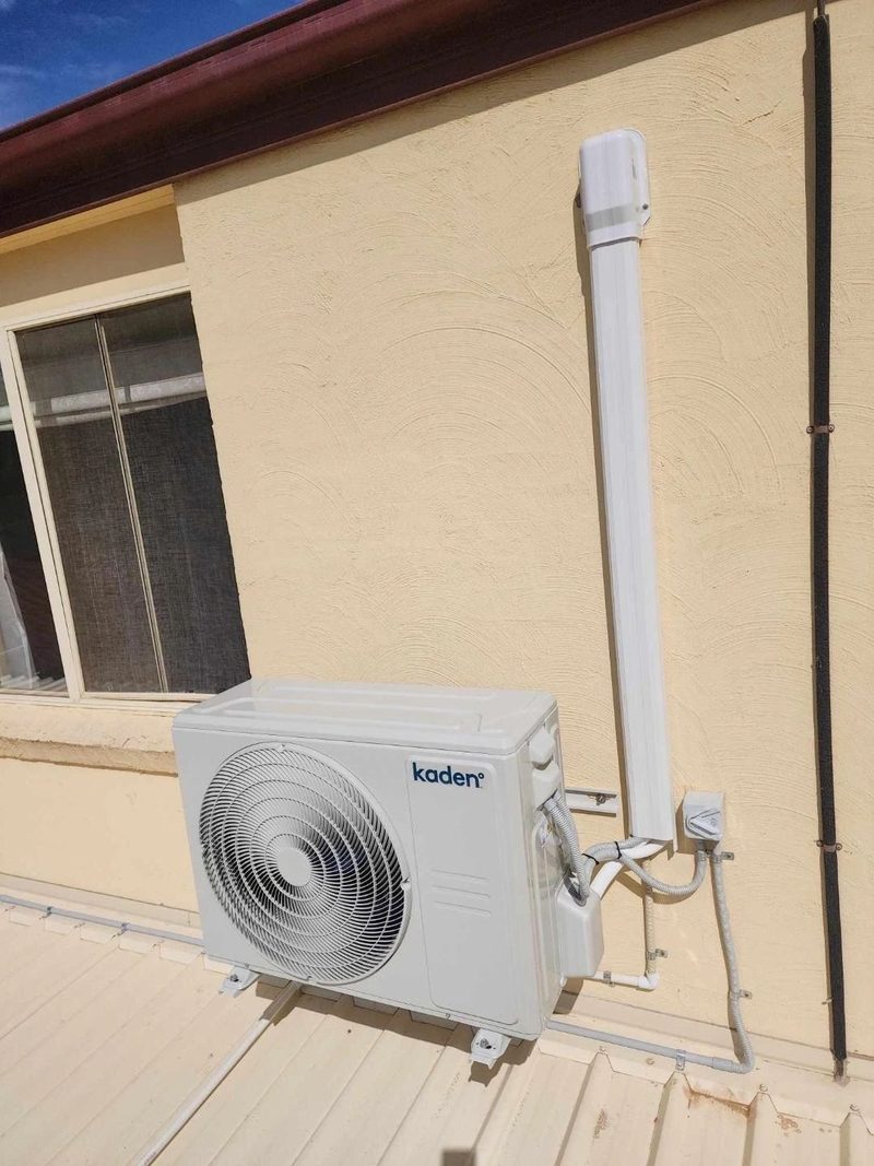 Split system install with conduit run clear of the roof sheet